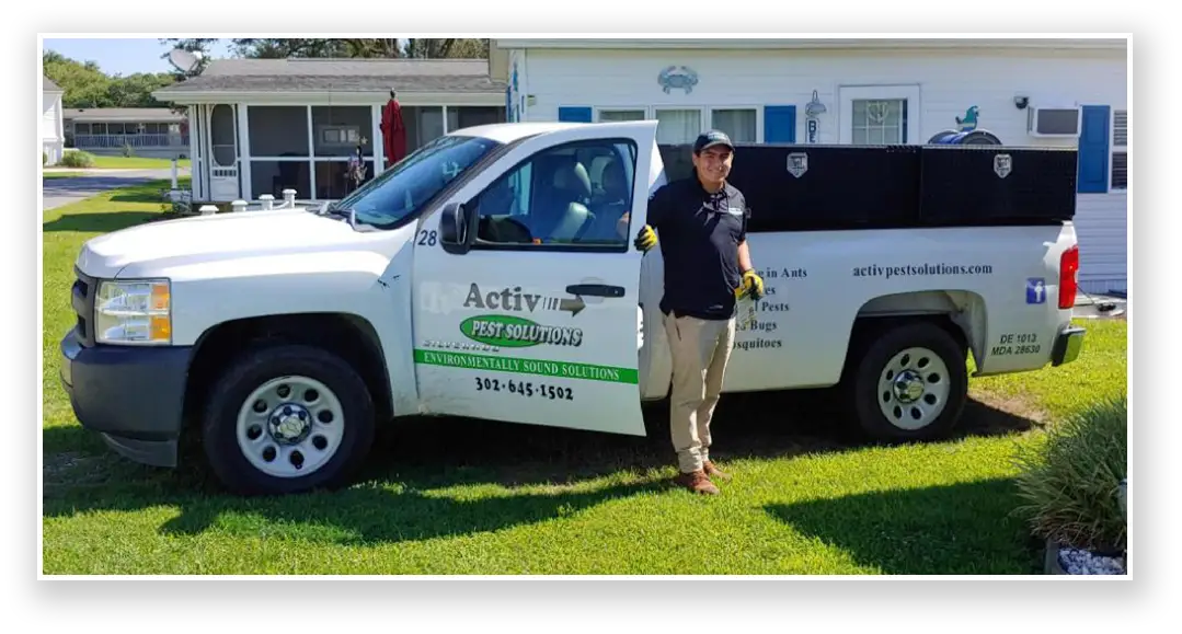Tech standing next to Activ Pest Solutions truck